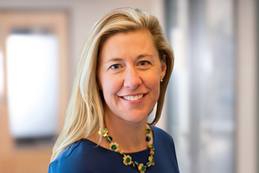 Photo of smiling businesswoman in hallway
